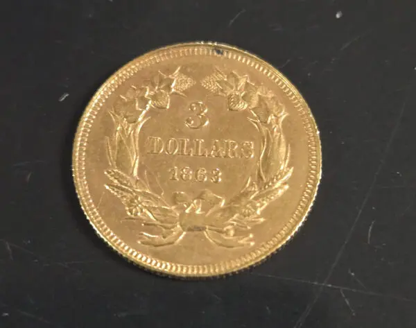 A gold coin sitting on top of a table.